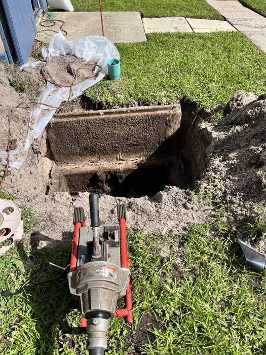 Sewer line service with a drain machine at an opened cleanout